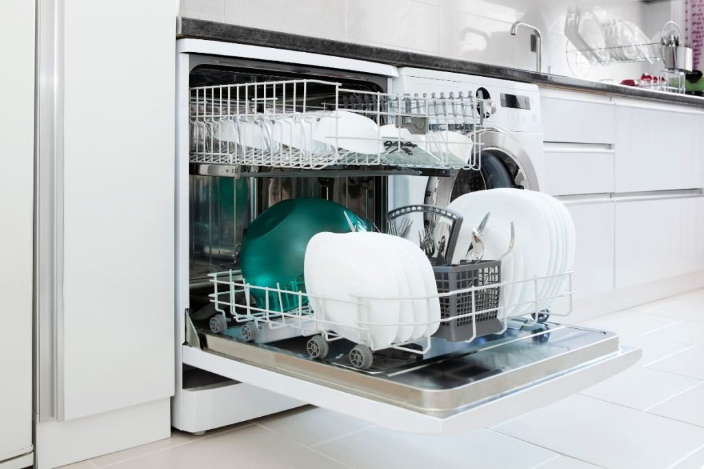 A dishwasher filled with clean dishes, showcasing a variety of plates, cups, and utensils neatly arranged inside.